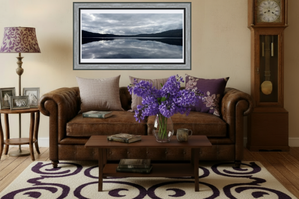 Living room with brown sofa, coffee table, and decorative items.