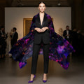 "A model in a sharp black tuxedo wearing the Petrichor Fine Art Black Fire Orchid silk shawl, showcasing the liquid-gold drape of 85gsm Mulberry Silk in a gallery setting."