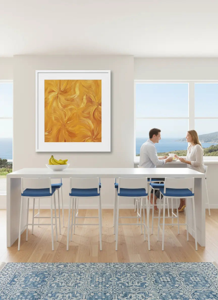 Modern kitchen with a couple sitting at a counter, artwork on the wall, and large windows.